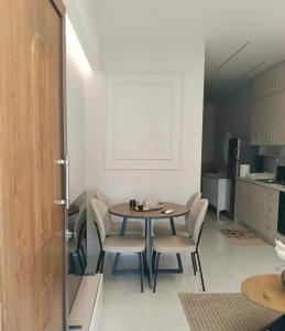 a dining room with a table and chairs in a kitchen at Garden apartment G in Xanthi