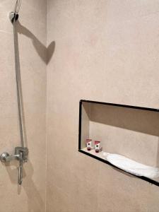 a mirror in a bathroom with two cups on a shelf at ايراد للشقق المفروشه in Dammam