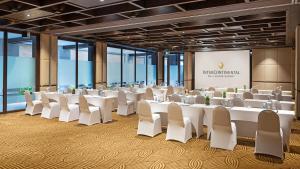 a conference room with white tables and white chairs at InterContinental Bali Sanur Resort by IHG in Sanur +190 photos