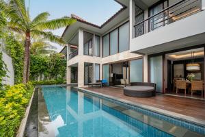 an exterior view of a villa with a swimming pool at InterContinental Bali Sanur Resort by IHG in Sanur