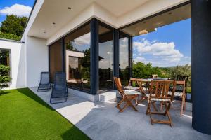 a dining room with a table and chairs on a patio at Apartma Belvi in Brežice