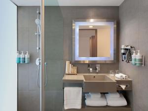 a bathroom with a sink and a shower at Novotel Bangkok on Siam Square in Bangkok +198 photos