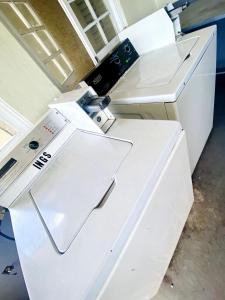 a white sewing machine sitting on top of a table at Grand One Bedroom Studio Apt in Kingston
