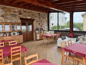 a restaurant with tables and chairs in a room at Posada El Nozal in Seña