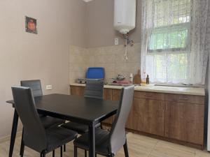 a dining room table and chairs in a kitchen at Okatse Lodge in Gordi