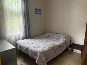 a small bedroom with a bed and a window at Okatse Lodge in Gordi