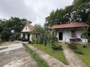 a house with a driveway next to a street at Okatse Lodge in Gordi +3 photos