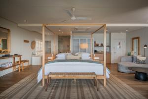 a bedroom with a large bed with a wooden frame at Sala Beach House in Ballito +80 photos