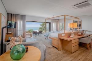a bedroom with a bed and a living room at Sala Beach House in Ballito