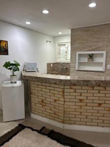 a bathroom with a sink and a counter with a plant at San Clemente Residence in Gramado +125 photos