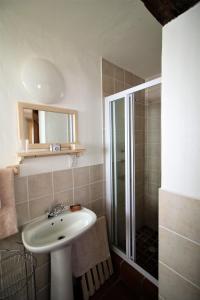 a bathroom with a sink and a shower at Baywatch Paternoster -The Villa in Paternoster