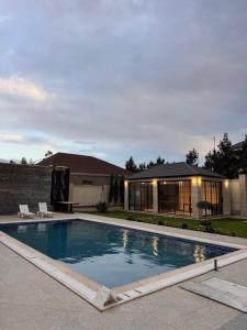 a swimming pool in front of a house at Villa in Baku