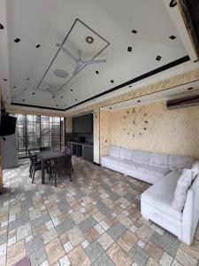 a living room with a white couch and a table at Villa in Baku