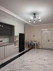 a kitchen and dining room with a table and chairs at Villa in Baku