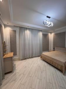 a large bedroom with a bed and a chandelier at Villa in Baku +30 photos