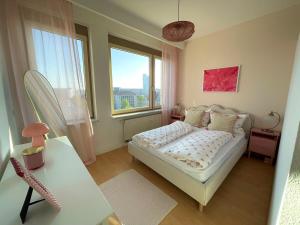 a small bedroom with a bed and a window at Panoramablick am Theaterplatz stilvolle Wohnung in Chemnitz