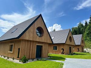 a large wooden barn with a gambrel roof at Chaty Gorcovia in Nowy Targ