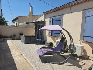 a chair sitting in front of a house at Le cocon de mag in Miramas