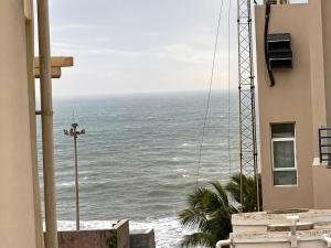 a view of the ocean from the balcony of a building at SEA BEACH HOTEL Near Swargadwar-Golden Beach- Jagannath Temple - PARK , Fully Air Conditioned Rooms ,Wifi , Lift , And Free Parking , BEST HOTEL IN PURI in Puri