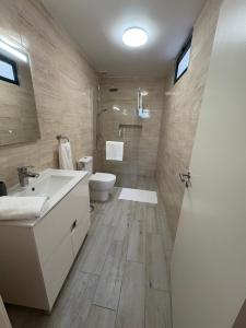 a bathroom with a sink and a toilet at Casa Barros in Campanário +50 photos