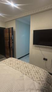a bedroom with a bed and a flat screen tv at The Rooms Lara in Antalya