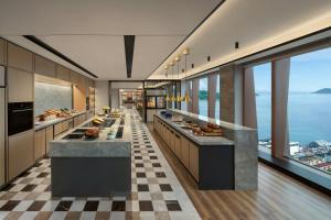 a large kitchen with a view of the ocean at Sheraton Kota Kinabalu in Kota Kinabalu