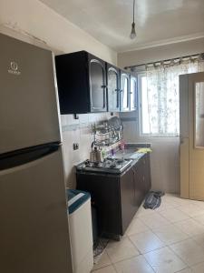 a kitchen with a sink and a stove top oven at Appartement Pour Vacances in Agadir