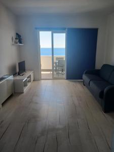 a living room with a couch and a view of the ocean at Apartments Maja in Hvar