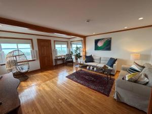 a living room with a couch and a table at Mount Hope Bay Cottage in Fall River
