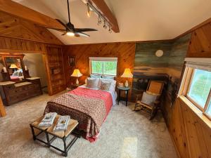 a bedroom with a bed in a room with wooden walls at Mount Hope Bay Cottage in Fall River