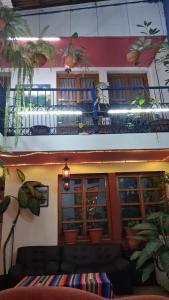 a building with a balcony with plants on it at hotel kasa kamelot parque in Quetzaltenango +6 photos