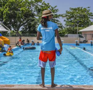 a young man standing in the water at a swimming pool at Soleya Studio in Le Moule +6 photos