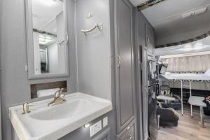 a bathroom with a sink and a mirror at Harley Davidson Ranch Glampling With Kids Play Zone in Ramona +74 photos