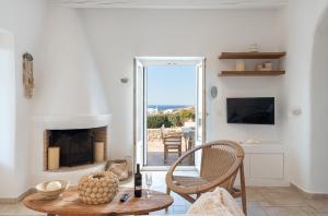 a living room with a table and a fireplace at Casa Elia in Sarakíniko