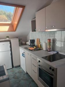 a kitchen with a sink and a stove top oven at Apartments Maja in Hvar