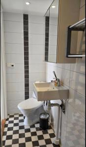 a bathroom with a toilet and a sink at Gäststugan in Åkersberga