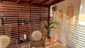 a patio with two chairs and a table and a fence at Arithea Hidden Seaside Heritage 2BR Suite in Paphos