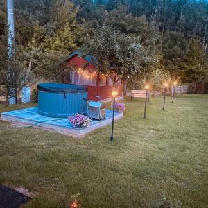 a gazebo in a yard at night with lights at Magia Leśnych Dolin Zwiartów 44, 22-610 Krynice in Zwiartów