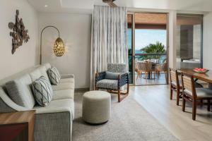 a living room with a couch and a dining room at The Westin Los Cabos Resort Villas in San José del Cabo