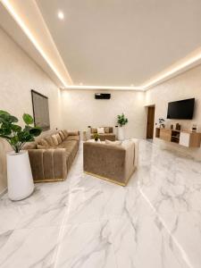 a large living room with couches and a television at Villa Oumnass, Marrakech in Oumnas