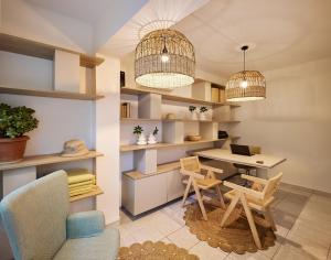 a room with a desk and chairs and two lights at Filoxenia Beach in Tsilivi