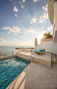 a swimming pool with a view of the ocean at Filoxenia Beach in Tsilivi