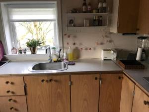 a kitchen counter with a sink and a window at Central apartment in Vestmanna in Vestmanna