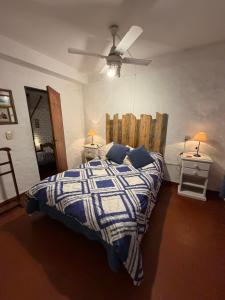 a bedroom with a bed and a ceiling fan at CASA JUNTO AL RIO in Paraná +20 photos