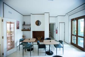 a dining room with two tables and chairs at Villa Sol Levante in Lequile