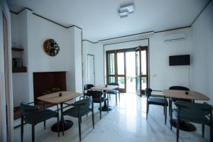 a room with tables and chairs and a fireplace at Villa Sol Levante in Lequile +60 photos
