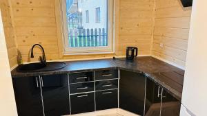 a kitchen with a sink and a window at Едем 2 in Verkhovyna