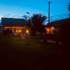 a building at night with lights in the yard at Magia Leśnych Dolin Zwiartów 44, 22-610 Krynice in Zwiartów +14 photos