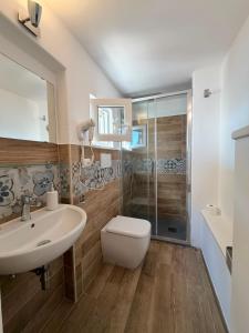 a bathroom with a toilet and a sink and a shower at Casa Ulivo in Ostuni +34 photos