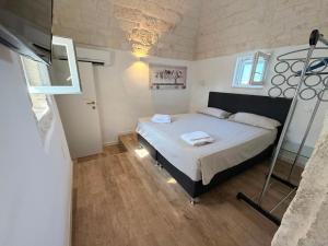 a bedroom with a bed and a ladder in it at Casa Ulivo in Ostuni